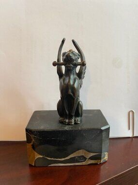 Vintage Bronze sculpture of a winged cheetah holding a rod, gold/black marble